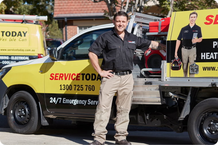 Service Today technician in uniform stands by a branded service vehicle offering 24/7 emergency leak detection.