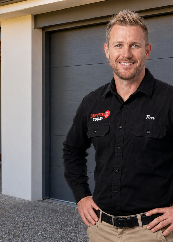 Ben from Service Today poses in front of a garage door.