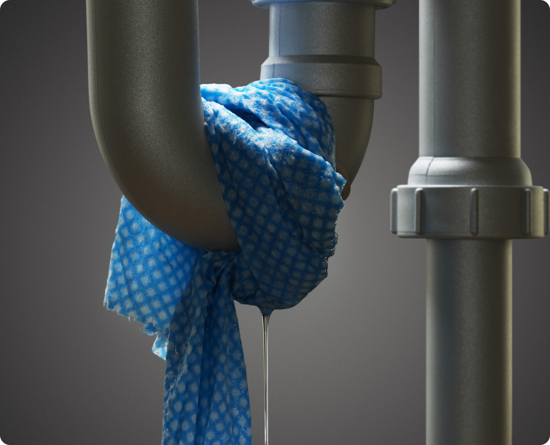 Blue cloth catches water dripping from a leaky pipe fitting.