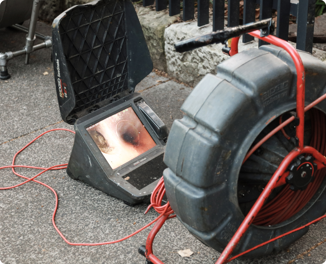 Drain inspection camera with monitor and reel of cable.