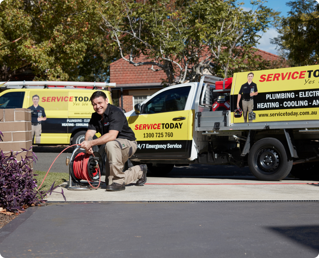 Plumber with drain snake from Service Today van, for blocked drain services.