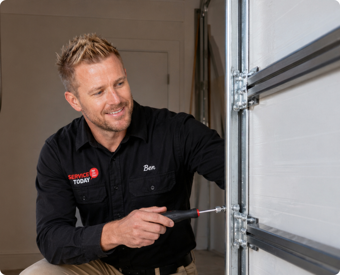 Technician Ben from Service Today works on a garage door track system.