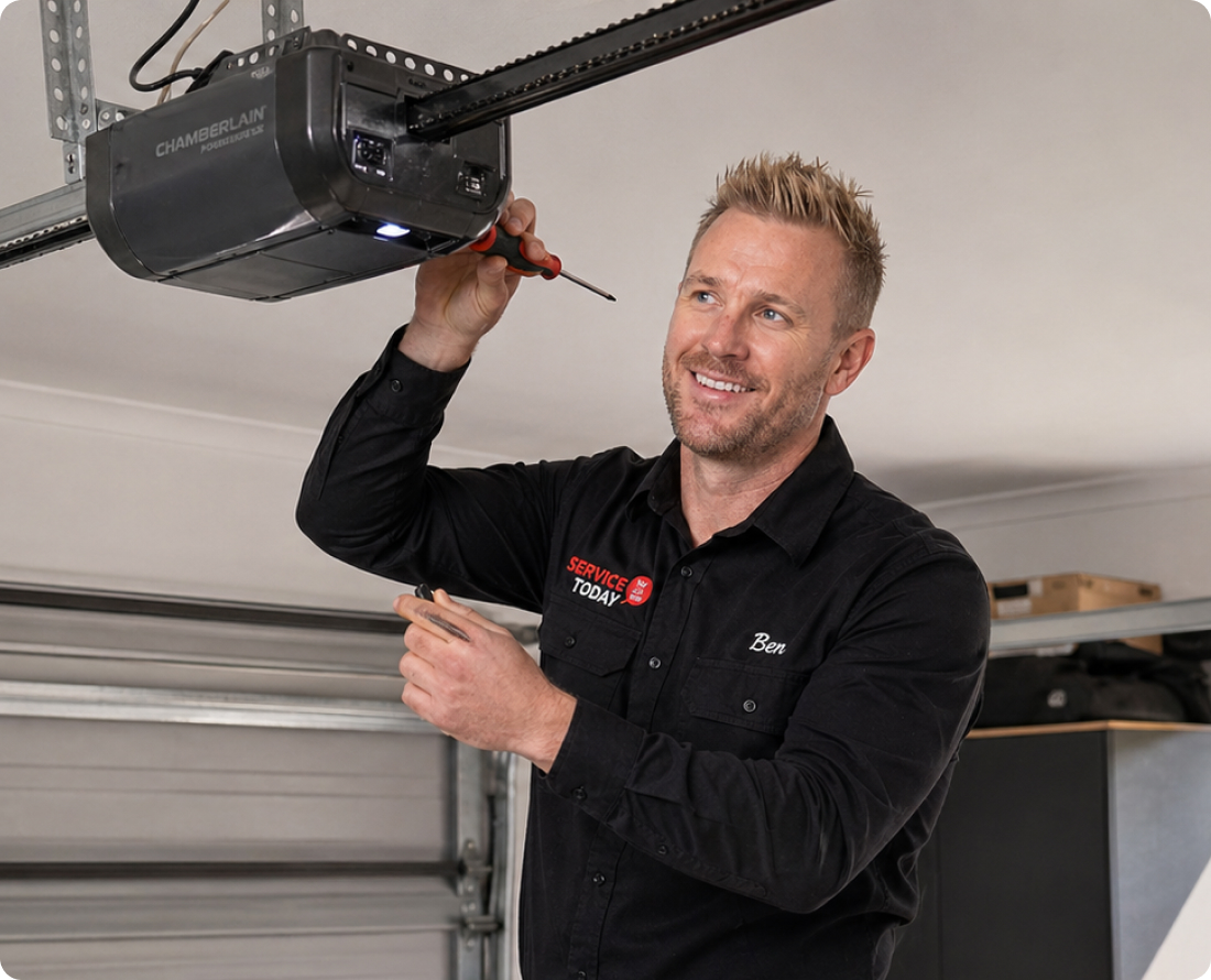 Technician Ben repairs a Chamberlain garage door opener with a screwdriver.